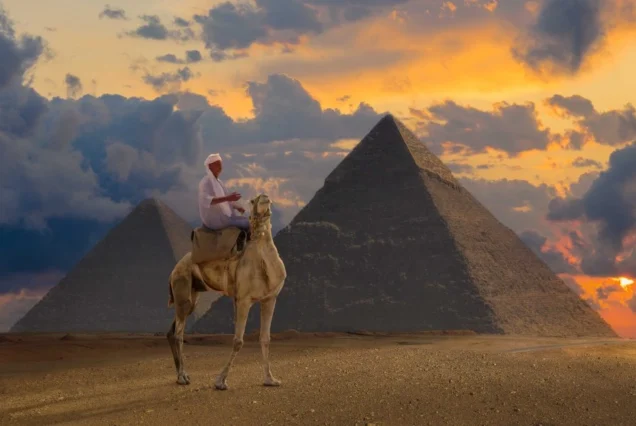Tourists taking photos in front of the Great Pyramids of Giza during their 8 day Egypt and Dubai tour